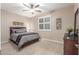 Inviting bedroom with a ceiling fan, neutral walls, and window with shutters at 1197 W Rolls Rd, San Tan Valley, AZ 85143