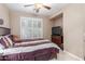 Bedroom boasts neutral walls, ceiling fan, and media cabinet at 1197 W Rolls Rd, San Tan Valley, AZ 85143