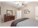 Bedroom offers neutral walls, ceiling fan, and dresser with large mirror at 1197 W Rolls Rd, San Tan Valley, AZ 85143