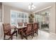 Dining room with a wooden table, patterned chairs, and a sliding glass door at 1197 W Rolls Rd, San Tan Valley, AZ 85143
