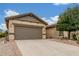 Attractive single-story home with a two-car garage, desert landscaping, and a well-maintained driveway at 1197 W Rolls Rd, San Tan Valley, AZ 85143