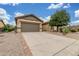 Charming single-story home featuring a two car garage, desert landscaping, and neutral color palette at 1197 W Rolls Rd, San Tan Valley, AZ 85143