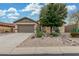 Charming single-story home featuring desert landscaping, a two-car garage and neutral colors at 1197 W Rolls Rd, San Tan Valley, AZ 85143
