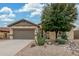 Charming single-story home featuring desert landscaping, a two-car garage and neutral colors at 1197 W Rolls Rd, San Tan Valley, AZ 85143