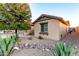 View of home showcasing desert landscaping, rocks, and a green tree at 1197 W Rolls Rd, San Tan Valley, AZ 85143