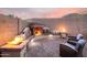 Beautifully designed outdoor fireplace with built-in seating and a cozy fire pit area at 1197 W Rolls Rd, San Tan Valley, AZ 85143