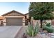 Inviting home exterior with a large cactus and desert landscaping at 1197 W Rolls Rd, San Tan Valley, AZ 85143