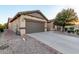 Inviting home exterior with desert landscaping and a spacious driveway at 1197 W Rolls Rd, San Tan Valley, AZ 85143