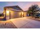 Inviting home exterior at sunset featuring a well-maintained driveway and desert landscaping at 1197 W Rolls Rd, San Tan Valley, AZ 85143