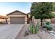 Charming home exterior with a well-kept lawn, mature tree, and desert landscaping at 1197 W Rolls Rd, San Tan Valley, AZ 85143