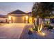 Charming home exterior showcasing a well-manicured yard with a large cactus and desert landscaping at 1197 W Rolls Rd, San Tan Valley, AZ 85143