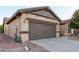 Attached two-car garage featuring a neutral door and stucco exterior at 1197 W Rolls Rd, San Tan Valley, AZ 85143
