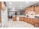 Spacious kitchen with warm wood cabinets, light countertops and adjacent breakfast nook at 1197 W Rolls Rd, San Tan Valley, AZ 85143