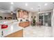 Bright kitchen area featuring neutral color palette, tile flooring, and breakfast nook at 1197 W Rolls Rd, San Tan Valley, AZ 85143