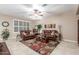 Cozy living room features neutral paint, plantation shutters and warm leather furniture at 1197 W Rolls Rd, San Tan Valley, AZ 85143