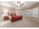 Spacious main bedroom featuring a ceiling fan and bay windows for natural light at 1197 W Rolls Rd, San Tan Valley, AZ 85143
