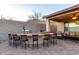 Inviting outdoor kitchen with a built-in bar, grill, and seating, perfect for entertaining at 1197 W Rolls Rd, San Tan Valley, AZ 85143