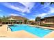 Community pool area with lounge chairs, umbrellas, and mountain views provides a relaxing outdoor retreat at 1197 W Rolls Rd, San Tan Valley, AZ 85143