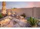 Rock water feature with a natural look, creating a tranquil backyard setting at 1197 W Rolls Rd, San Tan Valley, AZ 85143