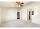 Spacious bedroom features neutral paint, plush carpeting, an entrance to an ensuite, and a walk-in closet at 1209 N 87Th St, Scottsdale, AZ 85257