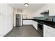Bright kitchen features white cabinets, stainless steel appliances, and black granite countertops with a blue backsplash at 1209 N 87Th St, Scottsdale, AZ 85257