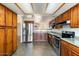 Spacious kitchen with stainless appliances, wooden cabinetry, and tiled flooring at 1209 N 87Th St, Scottsdale, AZ 85257