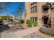 Beautiful building exterior with lush landscaping, mature trees, and a community pool at 12438 N Saguaro Blvd # 108, Fountain Hills, AZ 85268