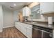 Well-lit kitchen featuring stainless steel dishwasher, white cabinets, and wood flooring at 12438 N Saguaro Blvd # 108, Fountain Hills, AZ 85268