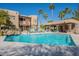 Inviting community pool surrounded by palm trees and comfortable lounge chairs at 12438 N Saguaro Blvd # 108, Fountain Hills, AZ 85268