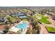 An aerial view showcases a community pool, tennis courts, and golf course, promising a resort-like lifestyle at 12915 W Micheltorena Dr, Sun City West, AZ 85375