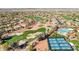 An aerial view of a community with a golf course, swimming pool, and tennis courts, offering a variety of recreational options at 12915 W Micheltorena Dr, Sun City West, AZ 85375