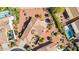 Expansive aerial view of a home showcasing its well-manicured landscaping, private pool, and tile roof at 12915 W Micheltorena Dr, Sun City West, AZ 85375