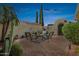 Charming outdoor patio features comfortable seating, desert landscaping, and a decorative arched gate at 12915 W Micheltorena Dr, Sun City West, AZ 85375