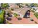A private backyard featuring a covered patio and low-maintenance landscaping with desert-style rock and mature landscaping at 12915 W Micheltorena Dr, Sun City West, AZ 85375