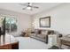 Cozy bedroom featuring a comfortable sofa, ample natural light, and neutral decor at 12915 W Micheltorena Dr, Sun City West, AZ 85375
