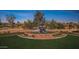 A decorative fountain marks the entry to Corte Bella with beautiful landscaping and well-maintained surroundings at 12915 W Micheltorena Dr, Sun City West, AZ 85375