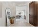 Inviting foyer with tile flooring, decorative mirror, and view of the dining room at 12915 W Micheltorena Dr, Sun City West, AZ 85375