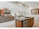 View of the kitchen island, dining area, and living room, creating an open and inviting space at 12915 W Micheltorena Dr, Sun City West, AZ 85375