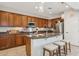 Modern kitchen features an island with seating, granite countertops, and stainless steel appliances at 12915 W Micheltorena Dr, Sun City West, AZ 85375