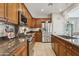 Well-equipped kitchen with stainless steel appliances, granite countertops, and ample cabinet space at 12915 W Micheltorena Dr, Sun City West, AZ 85375