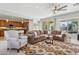 Spacious living room connects to the kitchen and features a large sectional sofa and stylish rug at 12915 W Micheltorena Dr, Sun City West, AZ 85375