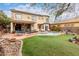 Backyard oasis featuring a pool, lush landscaping, large patio and comfortable outdoor furniture at 13331 W Romain Ct, Litchfield Park, AZ 85340