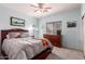 Cozy bedroom with neutral carpet and a large window dressed with wooden blinds at 13331 W Romain Ct, Litchfield Park, AZ 85340
