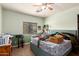 A bright bedroom with a window and disorganized personal items on the bed at 13331 W Romain Ct, Litchfield Park, AZ 85340