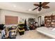 Bedroom or bonus room with a ceiling fan, natural light, and built-in shelving at 13331 W Romain Ct, Litchfield Park, AZ 85340