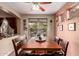 Cozy dining room featuring a wooden table, bench seating, and sliding door access to the backyard at 13331 W Romain Ct, Litchfield Park, AZ 85340