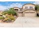 Inviting two-story home with a three-car garage and professionally landscaped yard at 13331 W Romain Ct, Litchfield Park, AZ 85340