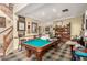 Spacious game room with pool table, with staircase leading to the second floor at 13331 W Romain Ct, Litchfield Park, AZ 85340