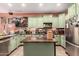 Well-equipped kitchen with green cabinetry, stainless steel appliances, and ample counter space at 13331 W Romain Ct, Litchfield Park, AZ 85340