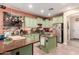 Well-equipped kitchen with green cabinetry, stainless steel appliances, and ample counter space at 13331 W Romain Ct, Litchfield Park, AZ 85340